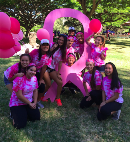 Student volunteers posed for group pictures after breaking down equipment at the Susan G. Komen race for a cure.
