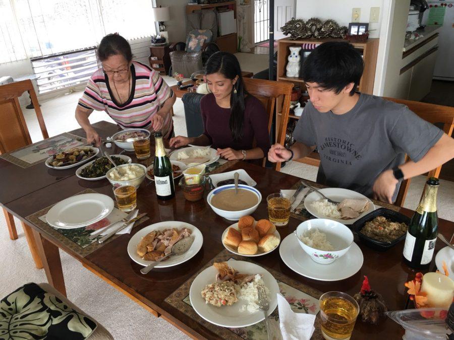 Editor and Chief Sasha Cox 12, and her boyfriend Marcus Young 12, enjoy a Thanksgiving meal with family. 