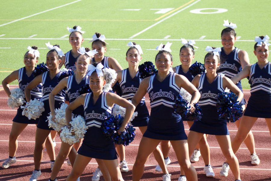 Cheer team gets in formation to begin a band dance.
