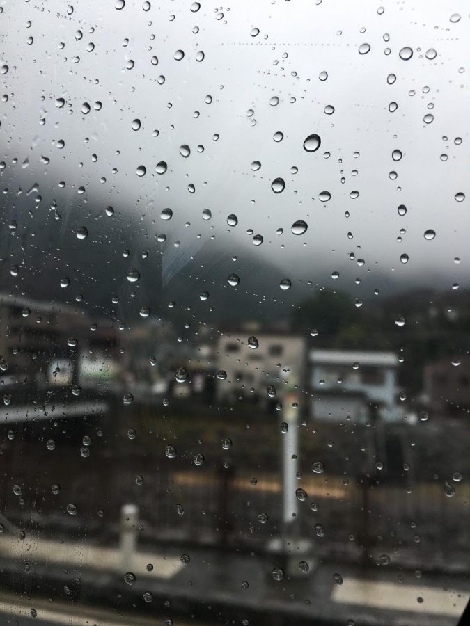 Raindrops on a window with muted colors evoking a sense of warmth and relaxation.