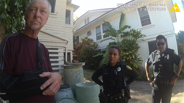 Jerry Hanel and Officer Enriquez (center) back in May 28, 2019, after his misuse of the 911 emergency service