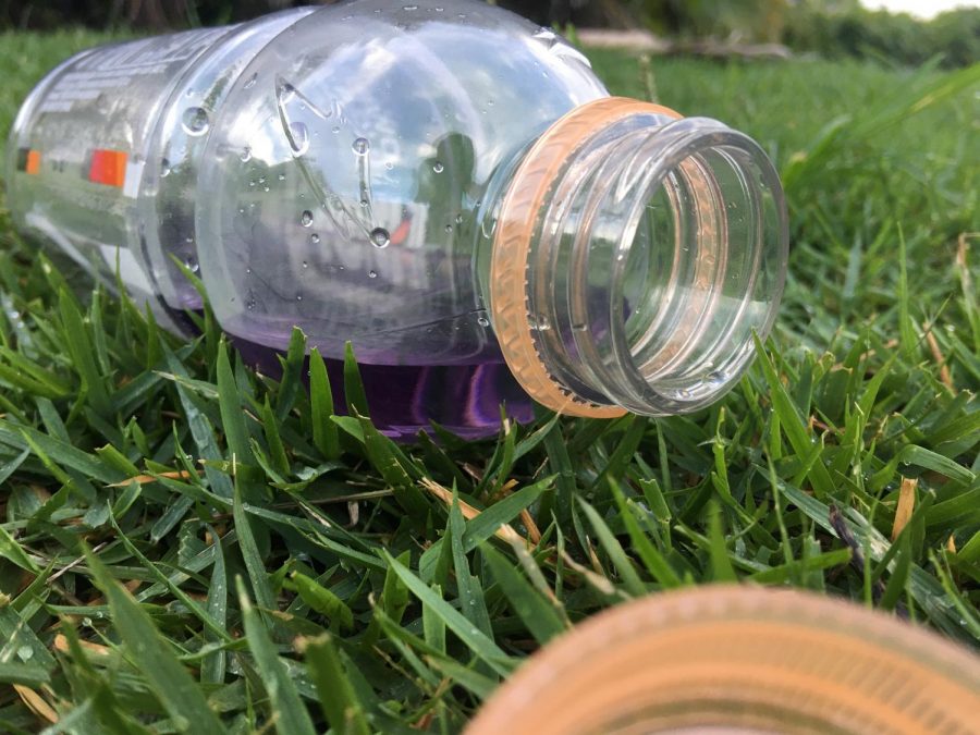 A+sports+drink+left+behind+on+a+grass+field%2C+is+just+one+of+the+many+single+use+plastics+that+are+discarded+during+sporting+events.+