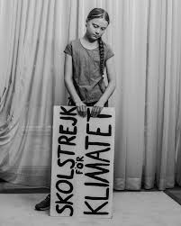 Greta Thunberg holding her sign that means “school strike for climate”, the same words that started her movement. 