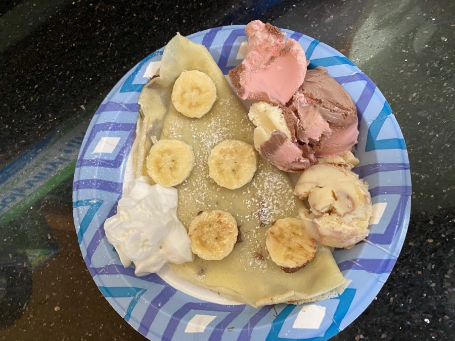 A banana Nutella crepe with a side of Neapolitan Ice Cream and Whip Cream. 