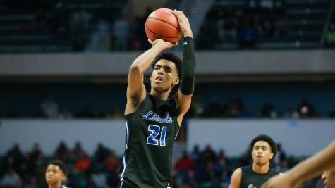 Photo Caption: Emoni Bates, class of 2022 plays basketball in a packed arena for Ypsi Prep Academy.