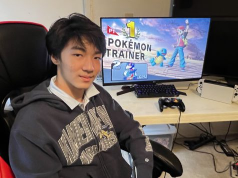 Low poses in front of his computer as he pulls a win.
