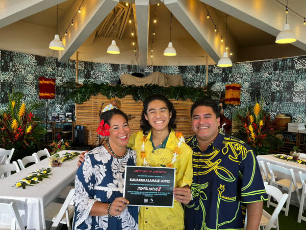 Kauakūkalahale Lopez posing for a picture with his mākua and certificate of completion for Kanaeokanas Digital NativeZ program. 