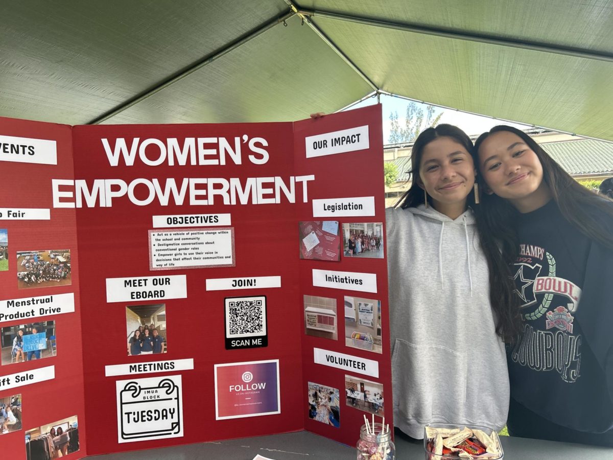 President Mikala Akiona and Co-Vice President Chloe Martin-Blevins next to the Womens Empowerment Club booth at this years Club Fair. 